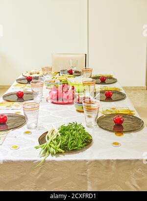 Festively decorated table for Rosh Hashanah with pomegranates and apples. Stock Photo
