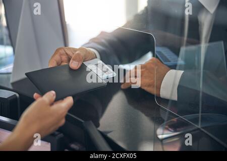 Male in suit checking in before flight Stock Photo