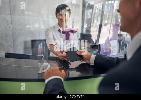 Happy mature man checking in before flight Stock Photo