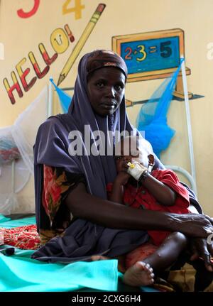 An unidentified Somali refugee woman holds her severely malnourished child inside the stabilization ward in the International Rescue Committee (IRC) clinic at the Hagadera refugee camp in Dadaab, near the Kenya-Somalia border, July 30, 2011. The whole of drought- and conflict-wracked southern Somalia is heading into famine as the Horn of Africa food crisis deepens, the United Nations said. In a report for countries sending aid, the U.N.'s umbrella humanitarian agency OCHA said the 'crisis in southern Somalia is expected to continue to worsen through 2011, with all areas of the south slipping i