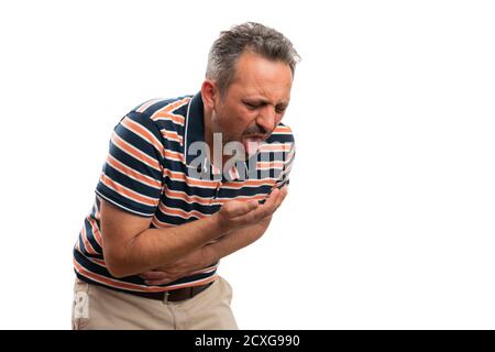 Ill adult man holding stomach having indigestion making puke or vomit gesture wearing casual summer attire with blank copyspace for advertising isolat Stock Photo