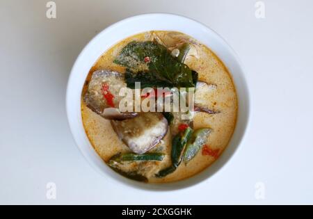 Sayur lodeh or curried vegetables on white background. Traditional Indonesian dish consisting of cabbage, long beans and eggplant,. Stock Photo