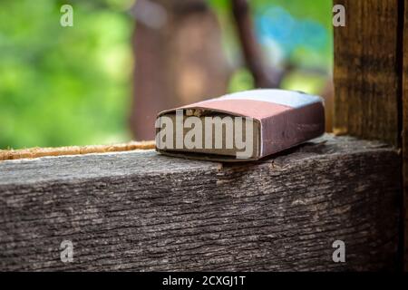 A close-up of a box of matches lies in the backyard. Stock Photo
