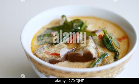 Sayur lodeh or curried vegetables on white background. Traditional Indonesian dish consisting of cabbage, long beans and eggplant,. Stock Photo