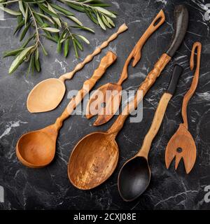 wooden kitchen tools on black marble in the kitchen Stock Photo