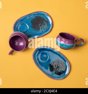 colorful ceramic coffee cups on yellow background isolated Stock Photo