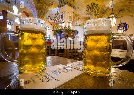 Munich, Germany. 30th Sep, 2020. Two full made-to-measure glass jugs stand on a table in the Hofbräuhaus in the city centre. On the table is a note stating that only five guests are allowed to stay together at this place. Credit: Peter Kneffel/dpa/Alamy Live News Stock Photo