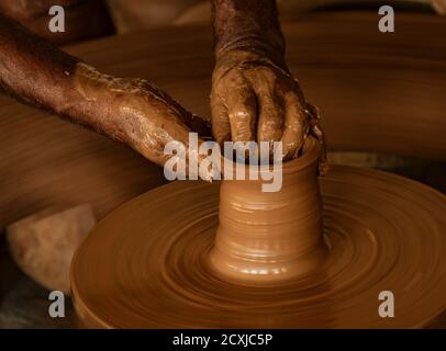 Madurai, India, Mar 10, 2018 - Man forms bowl on a manual pottery wheel with no electricity Stock Photo