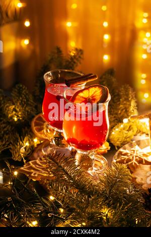 Christmas cozy still Life with glasses of warm red spicy drink. Stock Photo