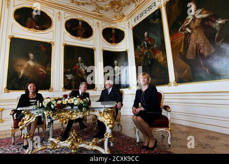 Czech President Vaclav Klaus (2nd R) meets his Hungarian counterpart Pal Schmitt (2nd L) during his visit at Prague Castle, April 21, 2011. Seated with them are Hungarian First Lady Katalin Schmittne Makray (R) and Czech First Lady Livia Klausova. REUTERS/Petr Josek (CZECH REPUBLIC  - Tags: POLITICS)