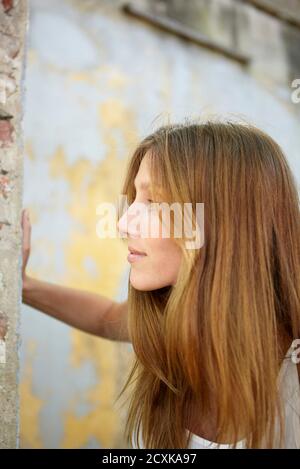 Young woman in abandoned house Stock Photo