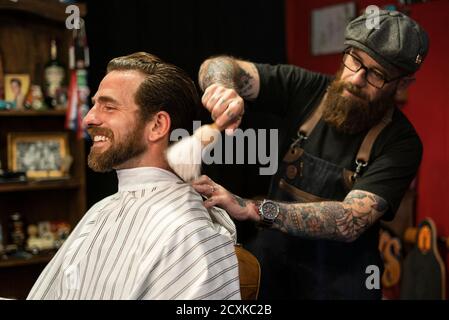Hairdresser cleaning client's neck Stock Photo