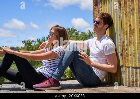 Young couple relaxing on balcony Stock Photo