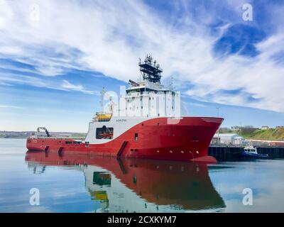 SCRABSTER, SCOTLAND - 2016 MAY 12. Offshore vessel AHTS Siem Opal moored inside harbour of Scrabster with blue skye and white clouds in the background Stock Photo