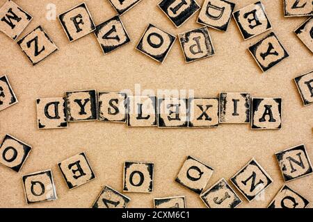 Cardboard letters made by alphabet stamps spelled out on cardboard  backgrounds Stock Photo - Alamy