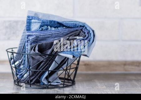 Kitchen towels and napkins in metal backet on a table. Zero waste, eco friendly concept. Stock Photo