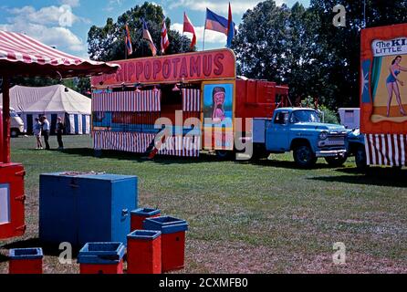 A vintage photograph of the sideshow alley at Clyde Beatty Cole Bros Brothers Combined Circus, USA c.1960. The attraction is Big Otto, the live hippopotamus. The painted advertising material displayed is now considered to be folk art. This image is from an old American amateur Kodak colour transparency. Stock Photo