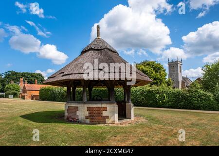 Woodbastwick village green with the church of Saint Fabian & Saint Sebastian in the background. Norfolk Broads, England Stock Photo