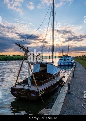 Boats moored on the River Bure for the night near St. Benet's Abbey, Norfolk Broads. Stock Photo