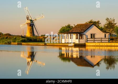 St Benet's Level Drainage Mill reflected in the river Thurne. Norfolk Broads, Norfolk, England. Stock Photo