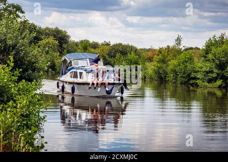 Boat sailing on the river Ant on the Norfolk Broads at How Hill, Ludham, Norfolk, England, UK. Stock Photo