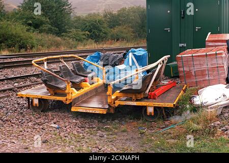 Edale, UK - 1 September 2020: A railway trolleys for carrying workers were placed on the trackside near Edale signal box. Stock Photo