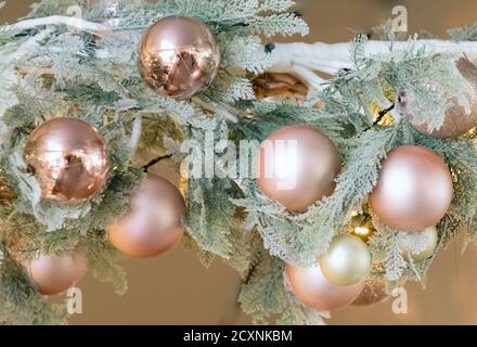 Christmas decorations hanging from ceiling in modern mall, shopping center or exhibition place. Baubles hanging on branch Stock Photo