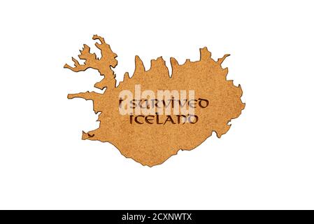 Map of Iceland on wood texture with the engraved inscription "I survived iceland", isolated on a white background. Stock Photo