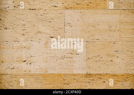 Close-up texture of beige travertine, on wall tiles. Stock Photo