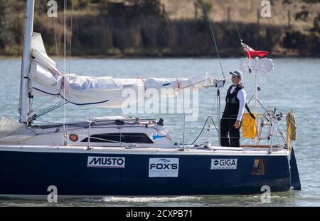 15-year-old Timothy Long sails his 28ft boat 'Alchemy' into Hamble Point Marina, Hampshire, becoming the youngest person to sail solo around Britain. Stock Photo