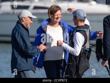 15-year-old Timothy Long (right) is embraced by his parents Nick Long (left) and Sue Elder (centre) after arriving back into Hamble Point Marina, Hampshire, becoming the youngest person to sail solo around Britain. Stock Photo