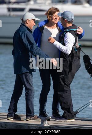 15-year-old Timothy Long (right) is embraced by his parents Nick Long (left) and Sue Elder (centre) after arriving back into Hamble Point Marina, Hampshire, becoming the youngest person to sail solo around Britain. Stock Photo