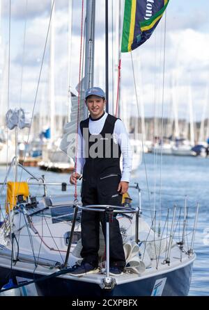 15-year-old Timothy Long poses for a photograph on his 28ft boat 'Alchemy' after arriving back into Hamble Point Marina, Hampshire, becoming the youngest person to sail solo around Britain. Stock Photo