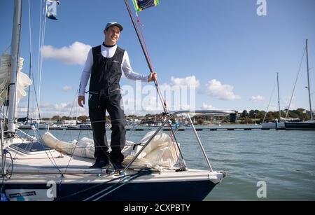 15-year-old Timothy Long poses for a photograph on his 28ft boat 'Alchemy' after arriving back into Hamble Point Marina, Hampshire, becoming the youngest person to sail solo around Britain. Stock Photo