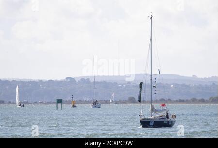 15-year-old Timothy Long sails his 28ft boat 'Alchemy' into Hamble Point Marina, Hampshire, becoming the youngest person to sail solo around Britain. Stock Photo