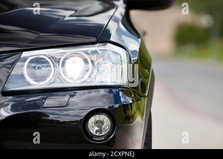 GRODNO, BELARUS - JUNE 2020: BMW X3 II F25 2.0i xDrive Black car parts left front headlight and fog light with part of bumper closeup selected focus Stock Photo