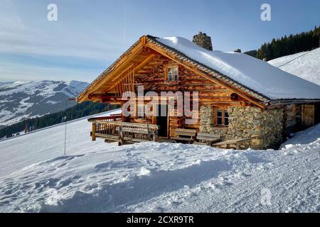 Snow covered mountain hut old farmhouse in the ski region of Saalbach Hinterglemm in the Austrian alps Stock Photo