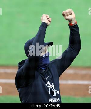 Cleveland, United States. 30th Sep 2020. . New York Yankees manager Aaron Boone (17) raises his hands in victory to team members in the stands after the Yankees clinched the AL Wild Card by defeating the Cleveland Indians at Progressive Field in Cleveland, Ohio on Wednesday, September 30, 2020. Photo by Aaron Josefczyk/UPI Credit: UPI/Alamy Live News Stock Photo