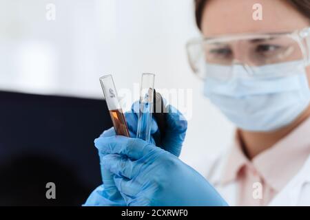 close up. female scientist marks tubes with tests. Stock Photo
