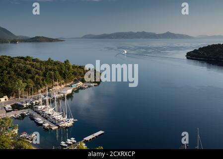 Superyacht motoring out of Spartahori harbour on the Ionian island of Meganisi. (Looking north towards islands of Skorpios and Lefkada) Greece Stock Photo