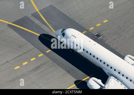 Aerial view of airport. Airplane taxiing to runway before take off. Stock Photo