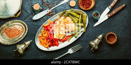 Appetizing fish grenadier roasted with vegetables.Seafood.Long banner Stock Photo