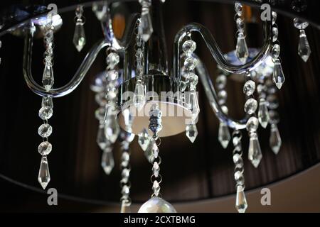 crystal chandelier on a black ceiling close-up Stock Photo