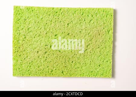 old used sponge for washing dishes on a light background Stock Photo