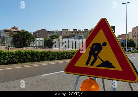 Triangle sign Work in progress. Roadworks, road signs. Men at work. Some signs signage for work in progress on urban street. Stock Photo