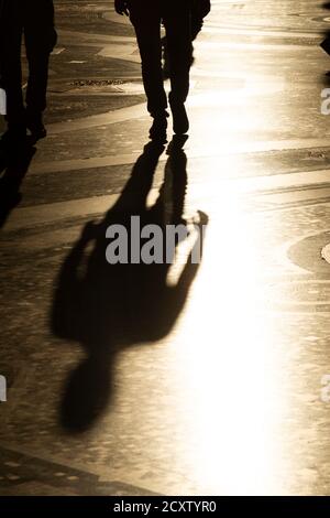 Italy, Lombardy, Milan, Galleria Vittorio Emanuele II, People Passing With Their Shadow on Mosaic Floor Stock Photo