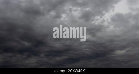 The night sky is covered with black storm clouds. Stock Photo
