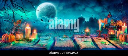 Wooden table with a full moon with dark cloudscapes on the night ...
