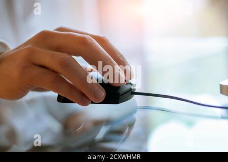 Close-up of laptop mouse and hand Stock Photo