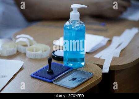 Bucharest, Romania - September 27, 2020: Shallow depth of field image with a voting stamp and disinfectant in a voting poll during the Covid 19 outbre Stock Photo